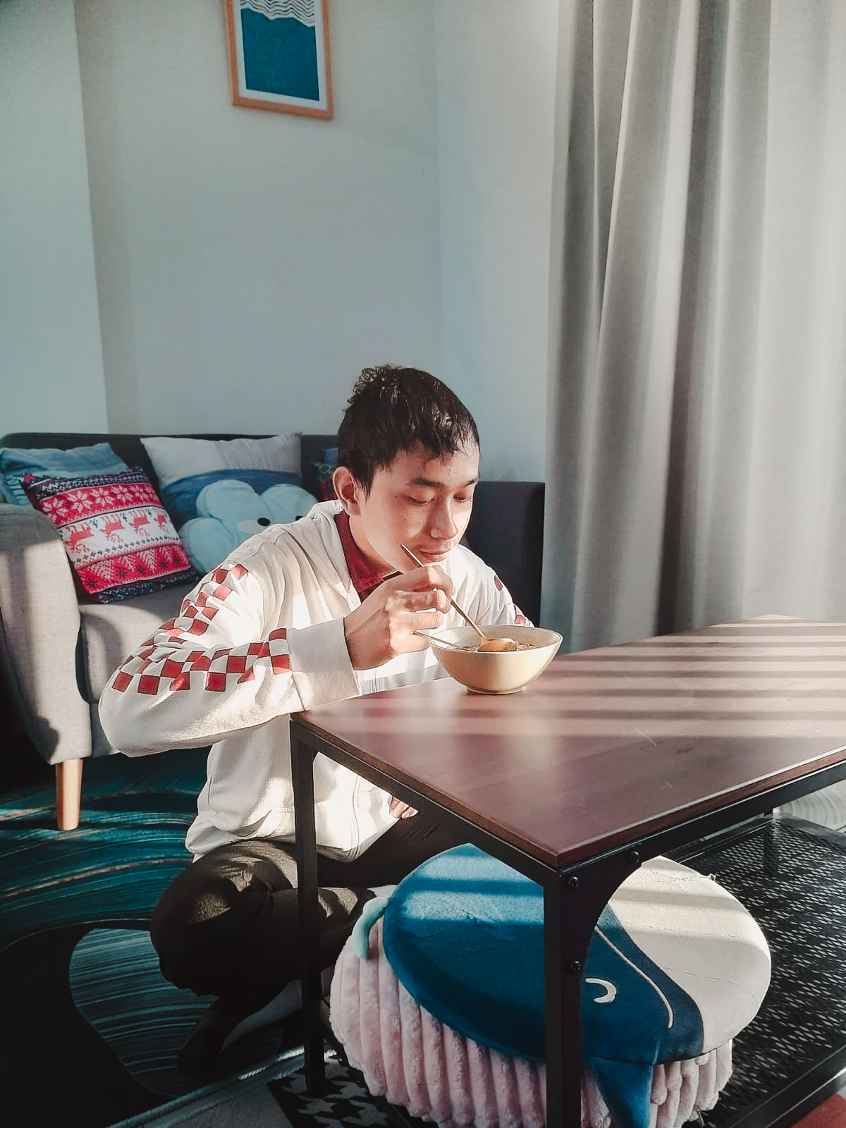 Romi eating noodles at the office